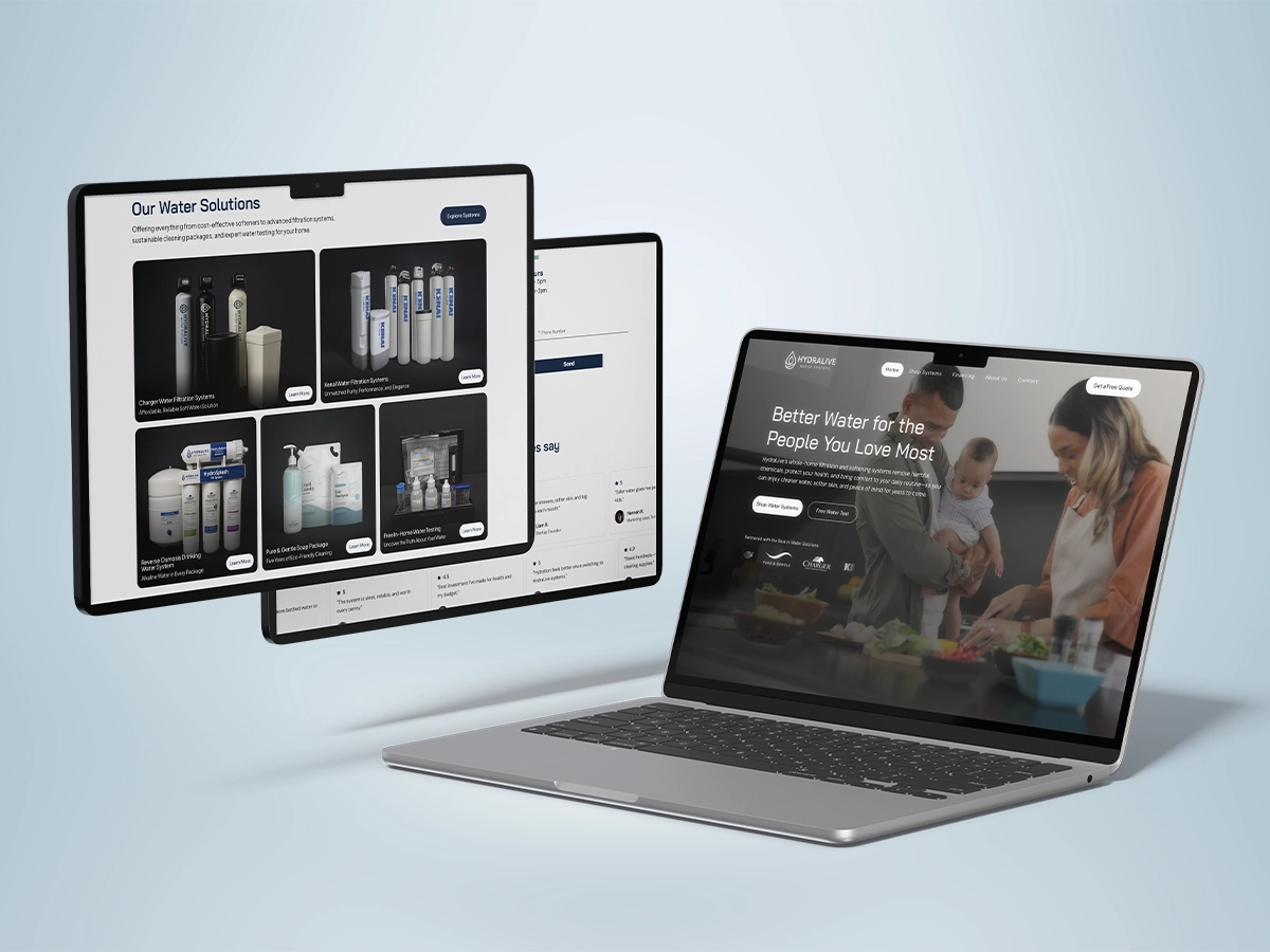 Laptop and tablet screens displaying the HydraLive water solutions website with product offerings and a family-focused homepage design.