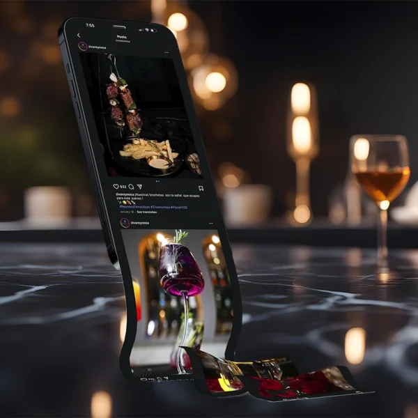 Creative concept of a smartphone on a marble table with its screen visually melting into flowing images of food and drinks.